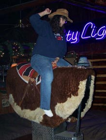 Photo: Woman riding mechanical bull