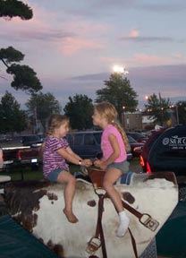 Photo sun setting mechanical bull riders